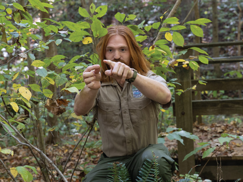 Skylar Gries, an Applied Biology major explains how to tell this is a Christmas fern (polystichum acrostichoides).