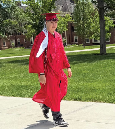 Michael Ingle in his cap and gown on the Oxford campus. 