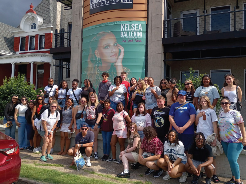 Group of Upward Bound students standing outside of Black River Entertainment in Nashville