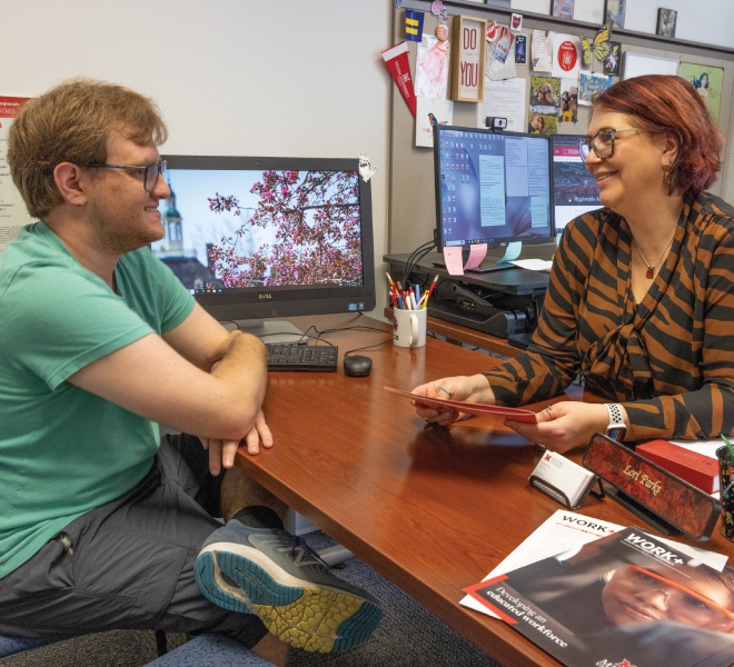 Academic Advisor Lori Parks meeting with a student in her office.
