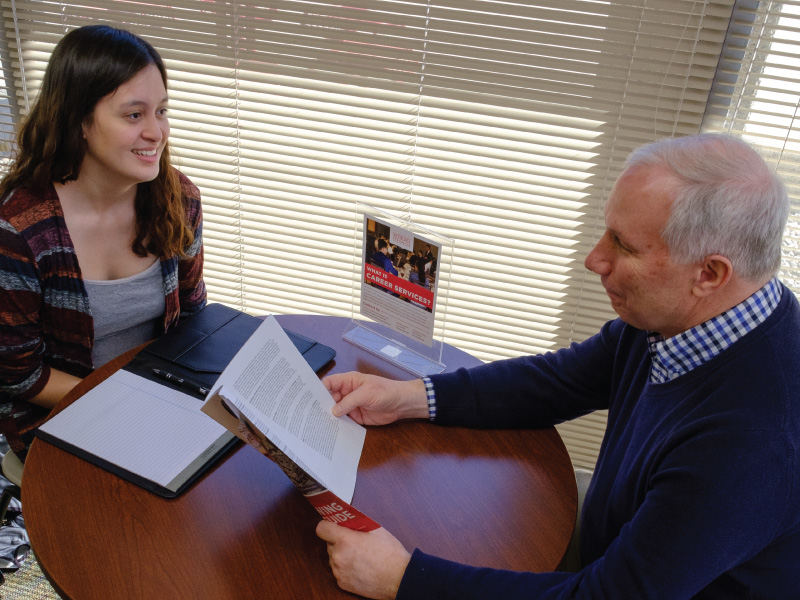 Doug Reichenberger meeting with a student to discuss their career goals