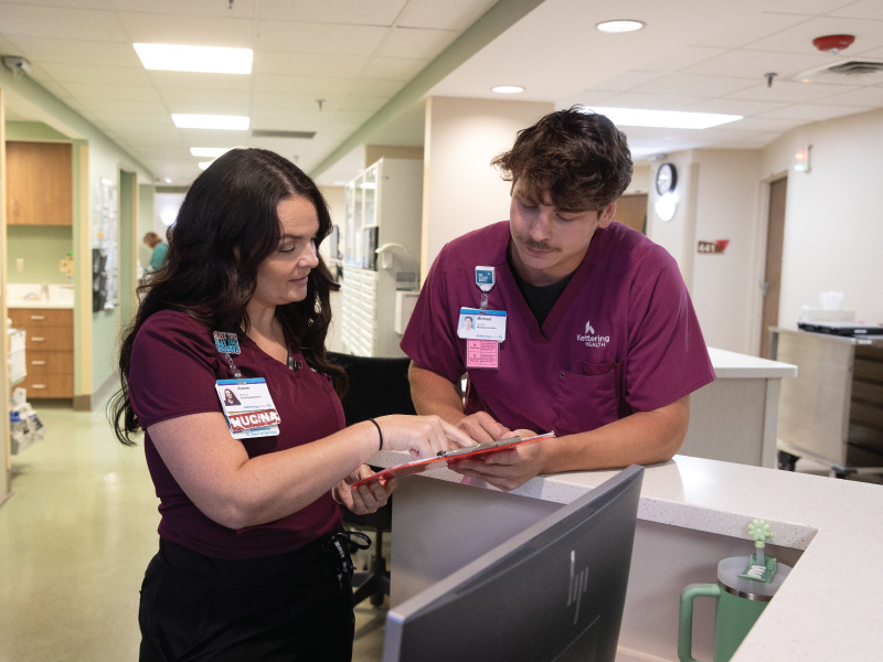 Work+ nursing students at Kettering Health talking with their supervisor.