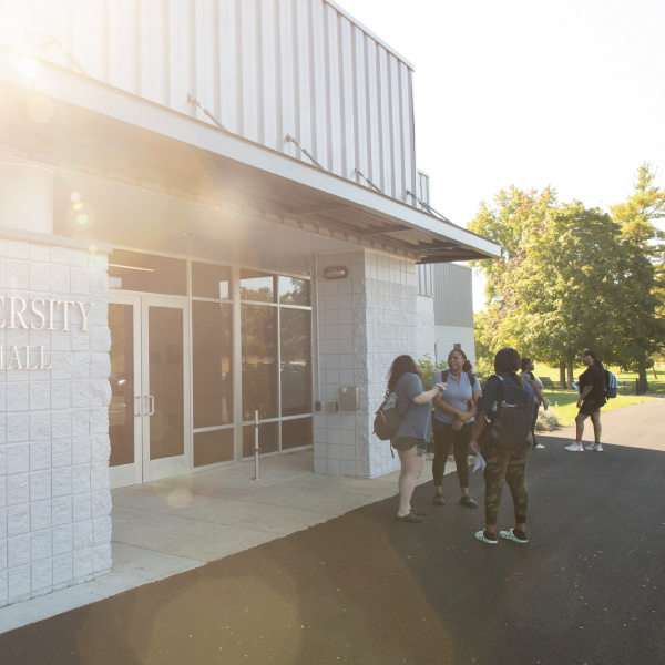Students talking outside of University Hall. 