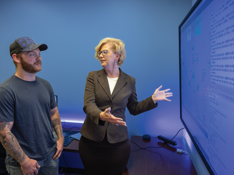 Miami CIT Faculty member talking with a student about cybersecurity.