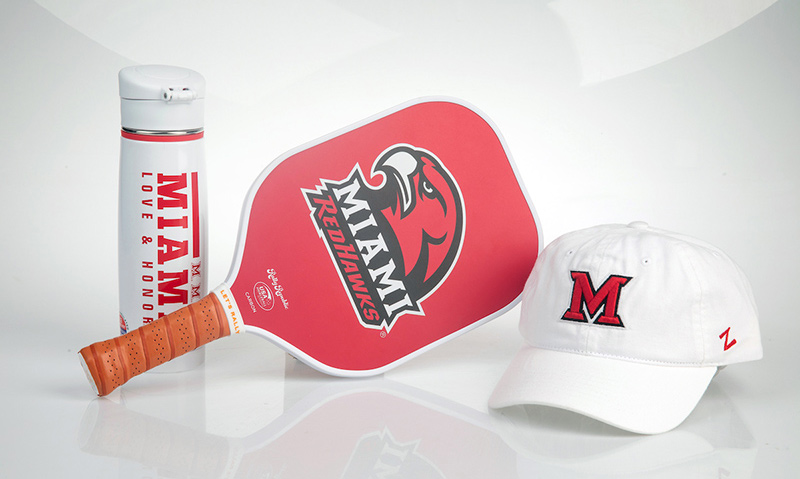 Miami branded water bottle, pickleball paddle, and hat