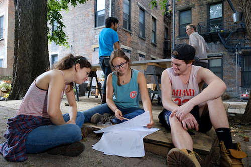 students volunteering at a home build