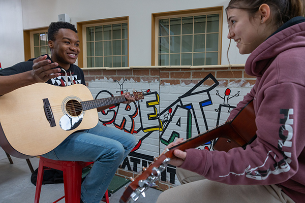 students making music together on guitars