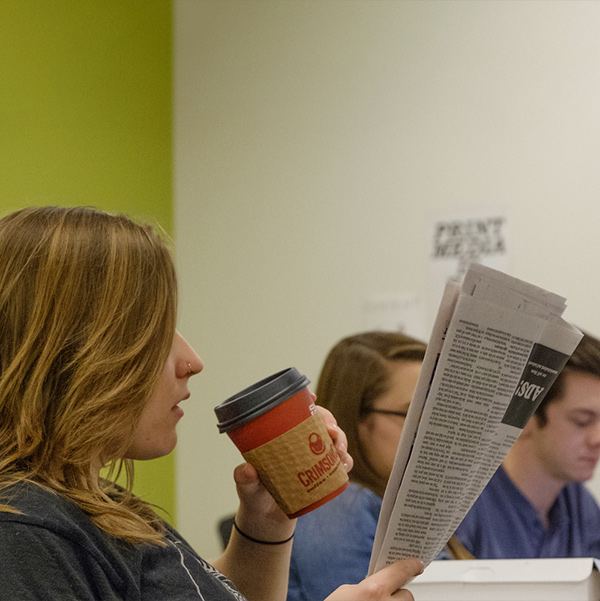 student reading a newspaper