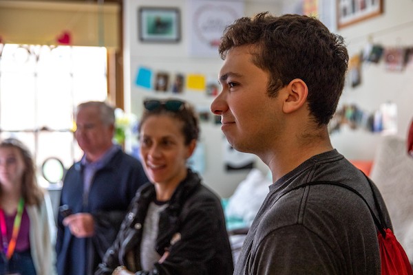 Newly admitted student touring a residence hall room with his parents