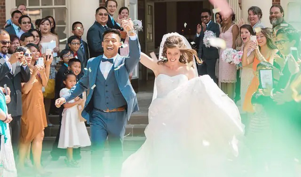 bride and groom celebrate outside sesquicentennial chapel